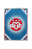1776 Tapestry Blanket — Jacquard woven cotton throw with a blue field, the Unofficial DC logo in a red circle with radiating sunburst, and red white and blue corner stripes carrying stars