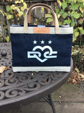 Back view of the Unofficial DC × Apolis Petite Market Bag in Navy, upright